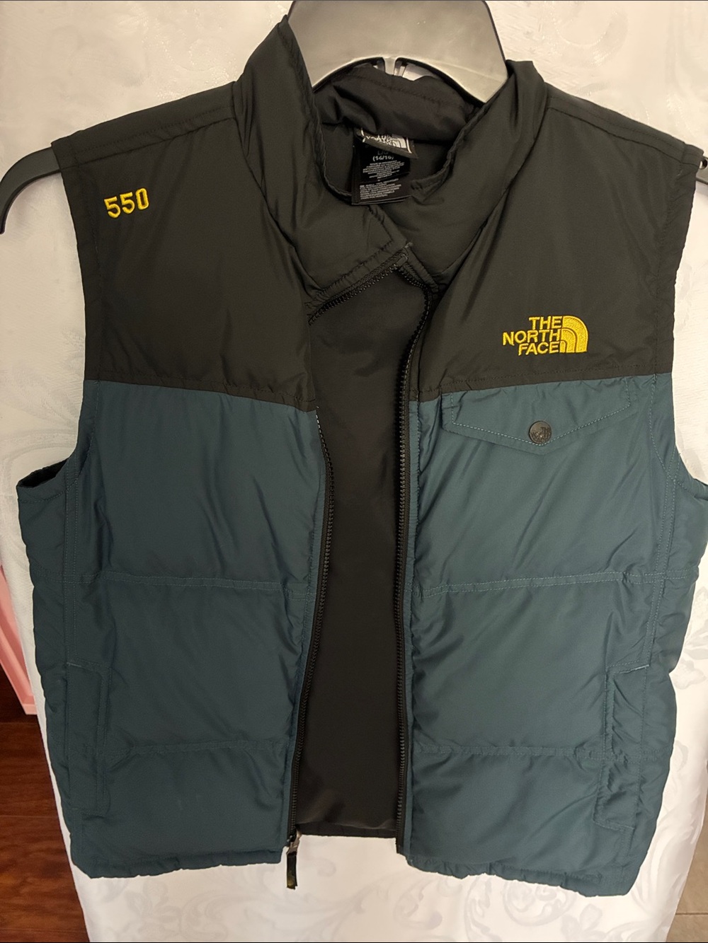 The North Face Kids or young men Teal and Black Insulated Vest with Yellow Logo